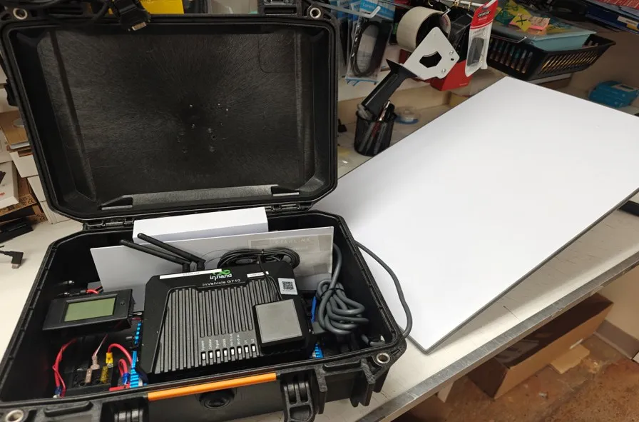 The MRF Dual-box in a rugged case, with an InHand VG710 router, power monitoring and wiring, beside a Starlink satellite dish