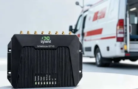 InHand VG710 in-vehicle router with its row of antenna connectors and status lights, in front of an ambulance