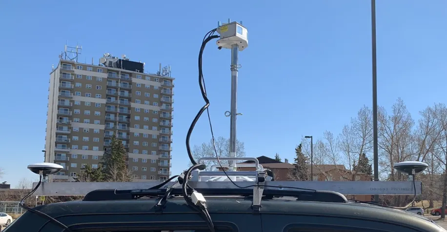 Solid-state LiDAR scanner and GNSS antennas mounted on a roof rack on a truck